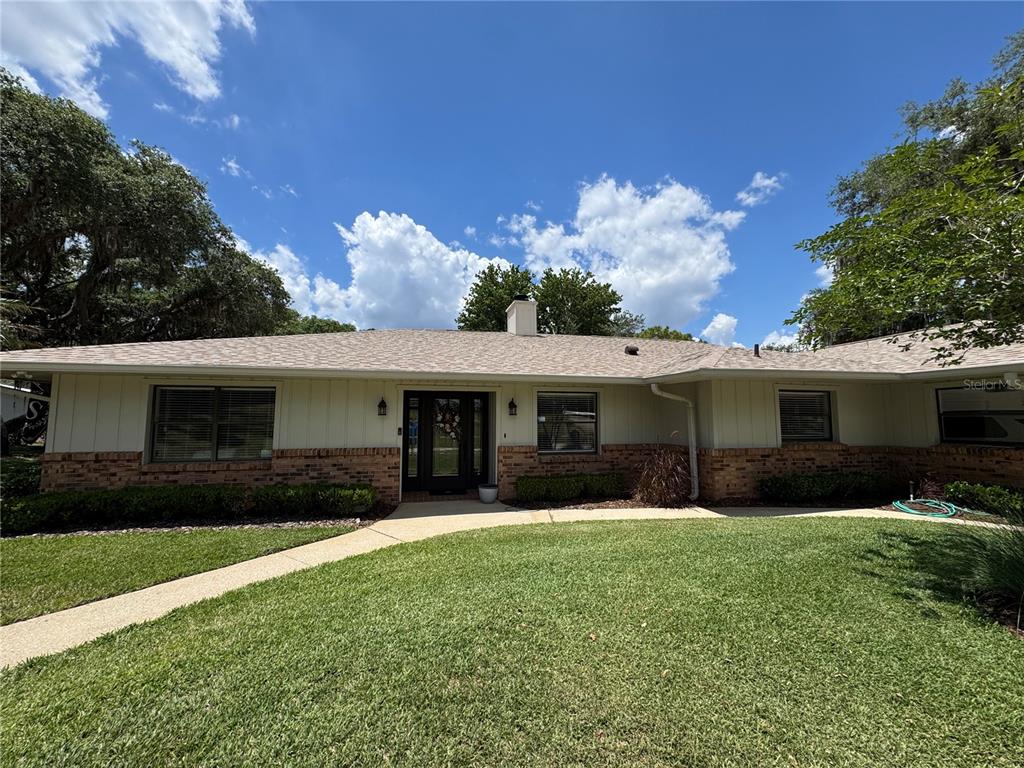 334 West F Street Frostproof, FL 33843 - Photo 2 of 48 a front view of house with yard and trees