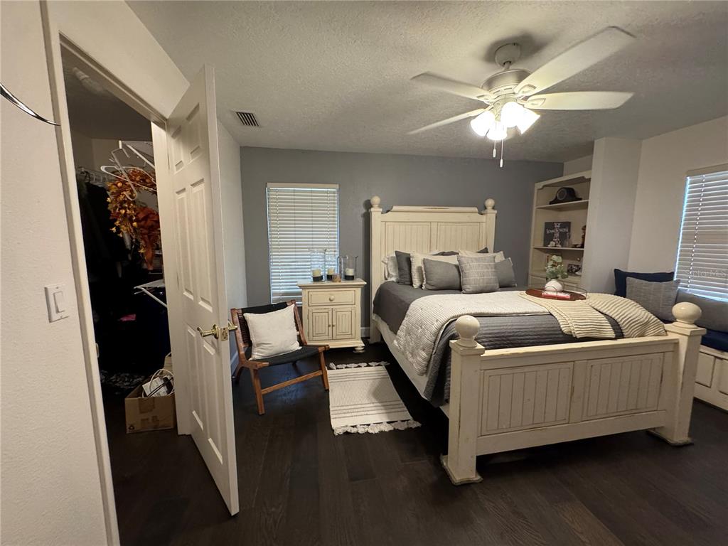 334 West F Street Frostproof, FL 33843 - Photo 21 of 48 a bedroom with a large bed and a chandelier