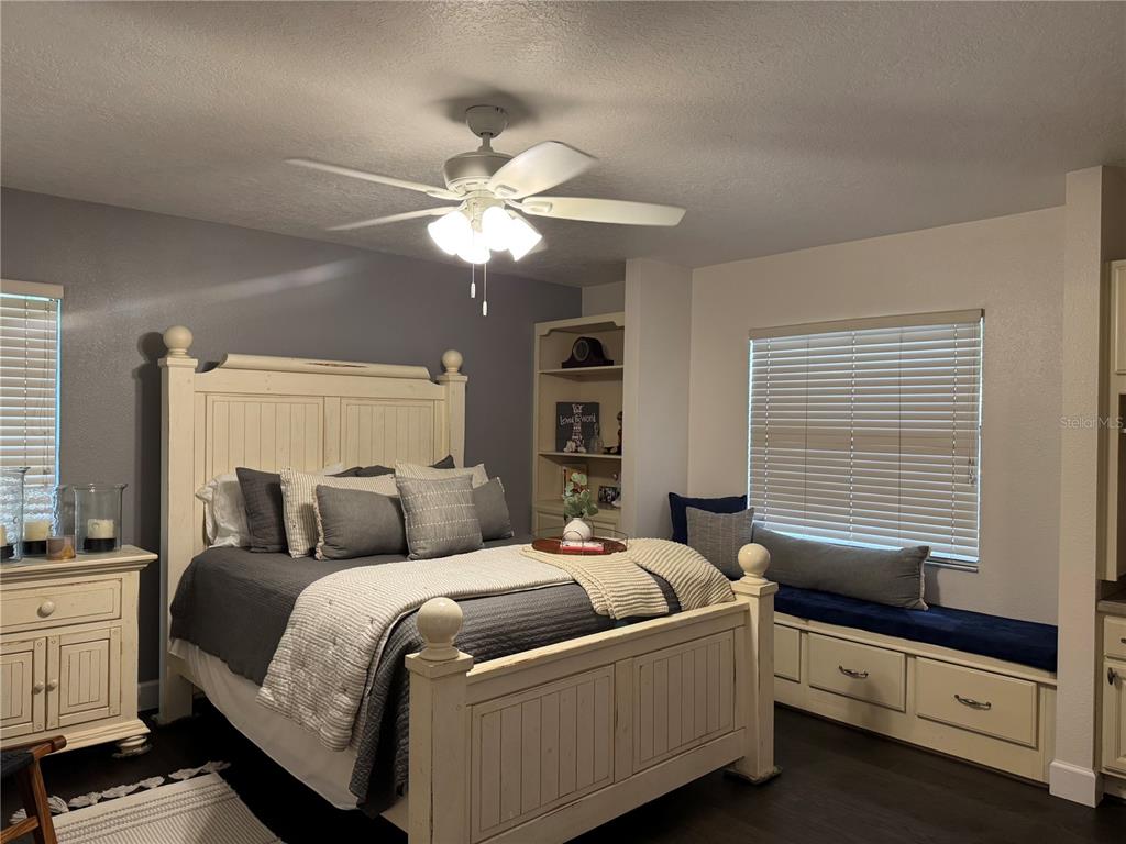 334 West F Street Frostproof, FL 33843 - Photo 22 of 48 a bedroom with a bed and a chandelier
