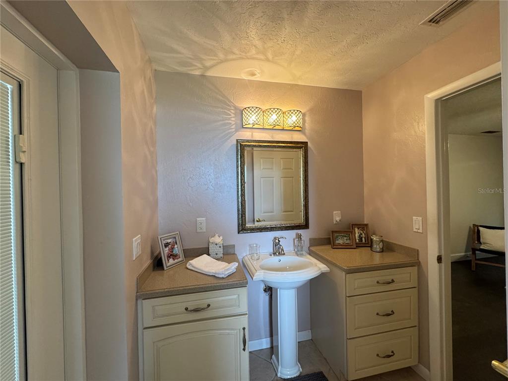 334 West F Street Frostproof, FL 33843 - Photo 23 of 48 a bathroom with a sink toilet and mirror
