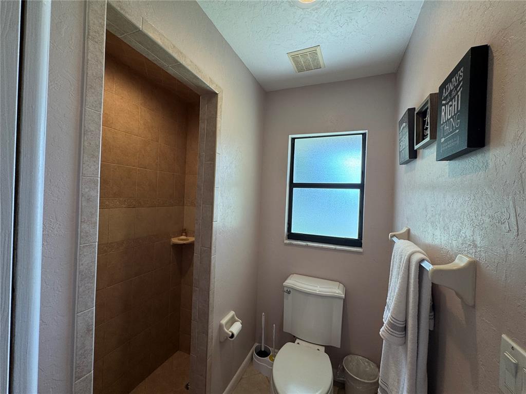 334 West F Street Frostproof, FL 33843 - Photo 24 of 48 a bathroom with a toilet sink and mirror