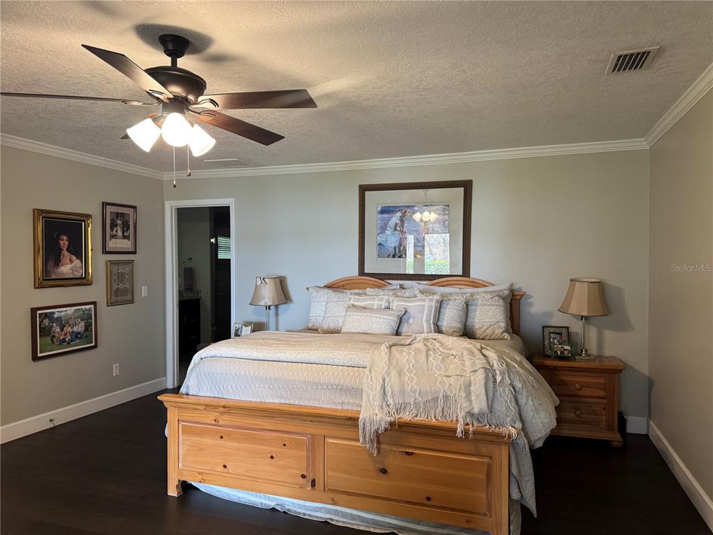 334 West F Street Frostproof, FL 33843 - Photo 25 of 48 a bedroom with a bed and a chandelier