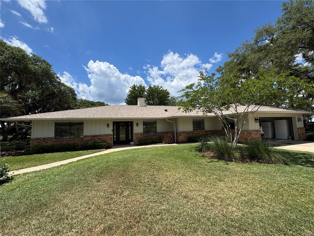 334 West F Street Frostproof, FL 33843 - Photo 3 of 48 a front view of a house with garden