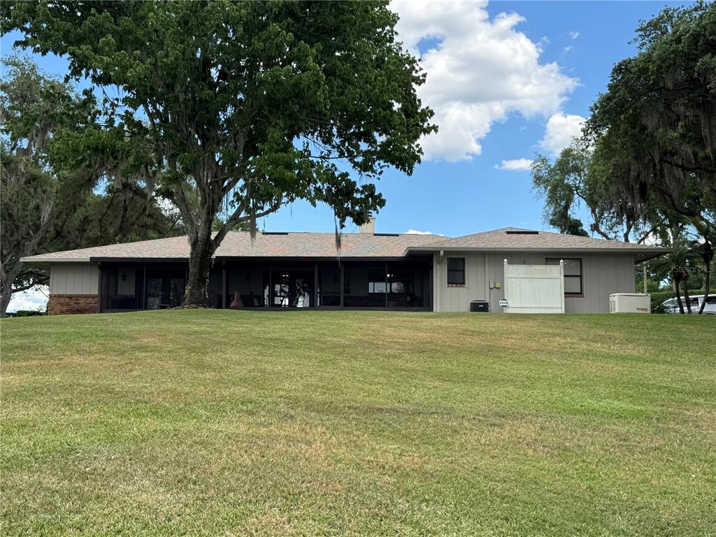 334 West F Street Frostproof, FL 33843 - Photo 39 of 48 a front view of a house with a garden