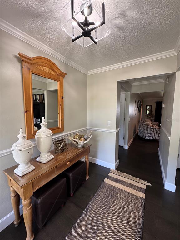 334 West F Street Frostproof, FL 33843 - Photo 4 of 48 a living room with table chairs and a chandelier