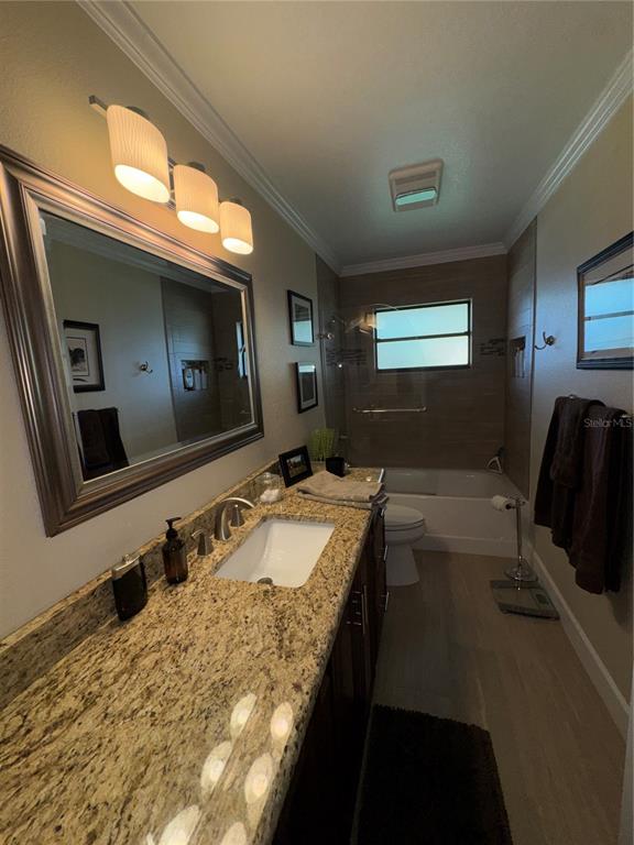 334 West F Street Frostproof, FL 33843 - Photo 7 of 48 a bathroom with a granite countertop sink and a mirror