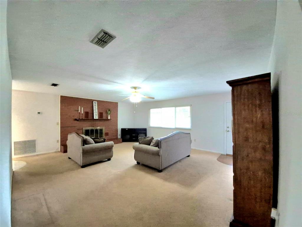 25632 Southwest 19 Avenue Newberry, FL 32669 - Photo 3 of 20 a living room with furniture and a flat screen tv