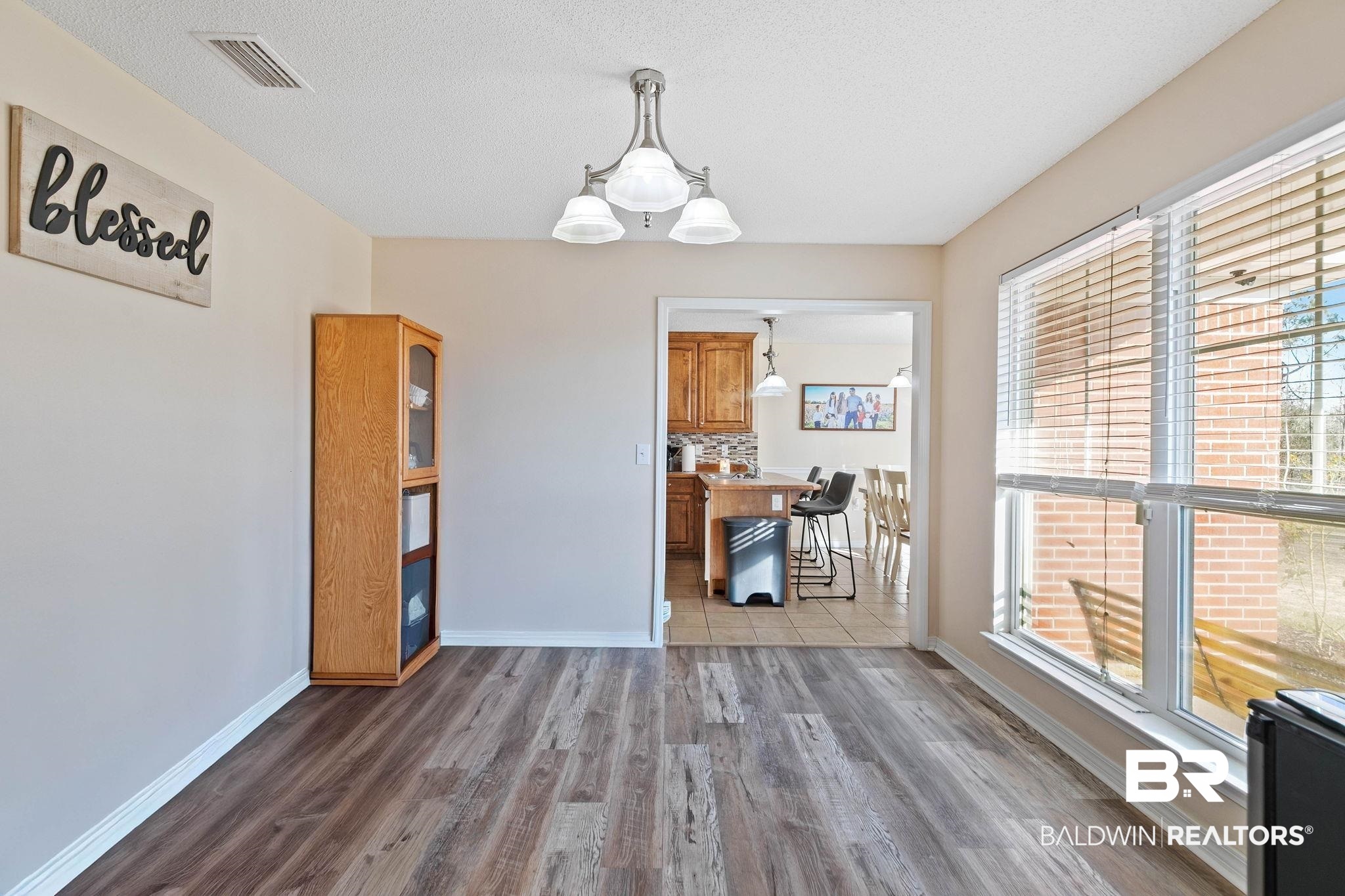 55750 Lottie Road Perdido, AL 36562 - Photo 58 of 84 Dining area featuring wood finished floors, hanging lights, and a textured ceiling