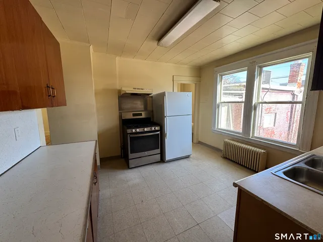 a kitchen with stainless steel appliances a refrigerator and a stove