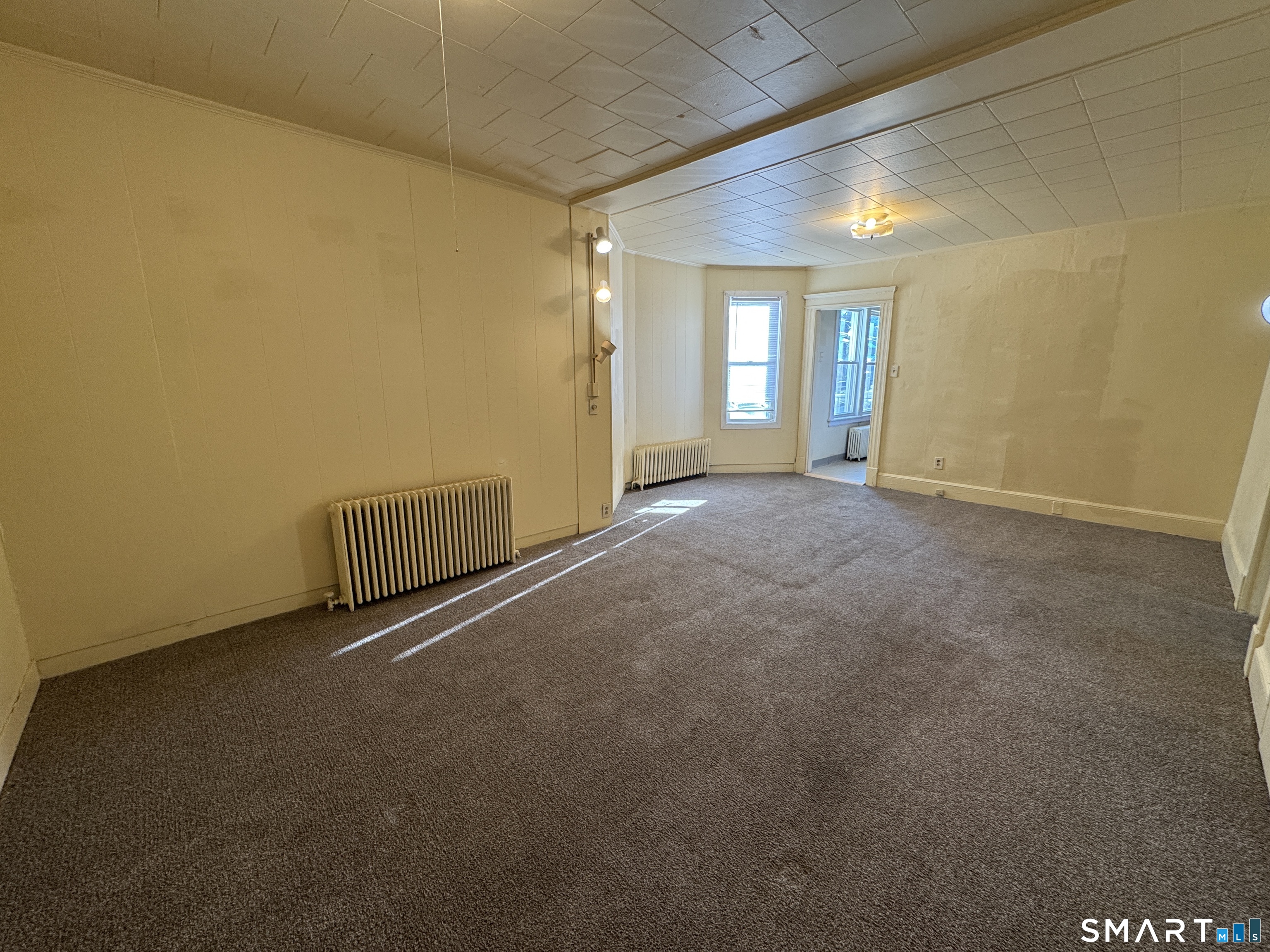 1720 East Main Street, Unit 1 Waterbury, CT 06705 - Photo 6 of 9 an empty room with windows
