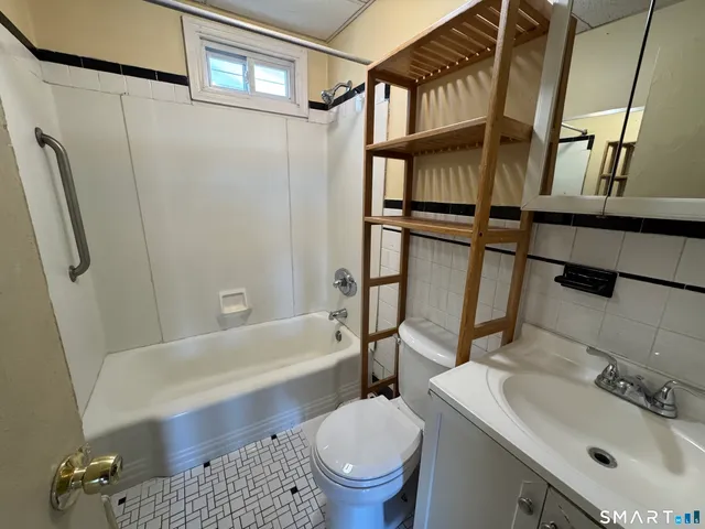 a bathroom with a sink toilet and a bathtub