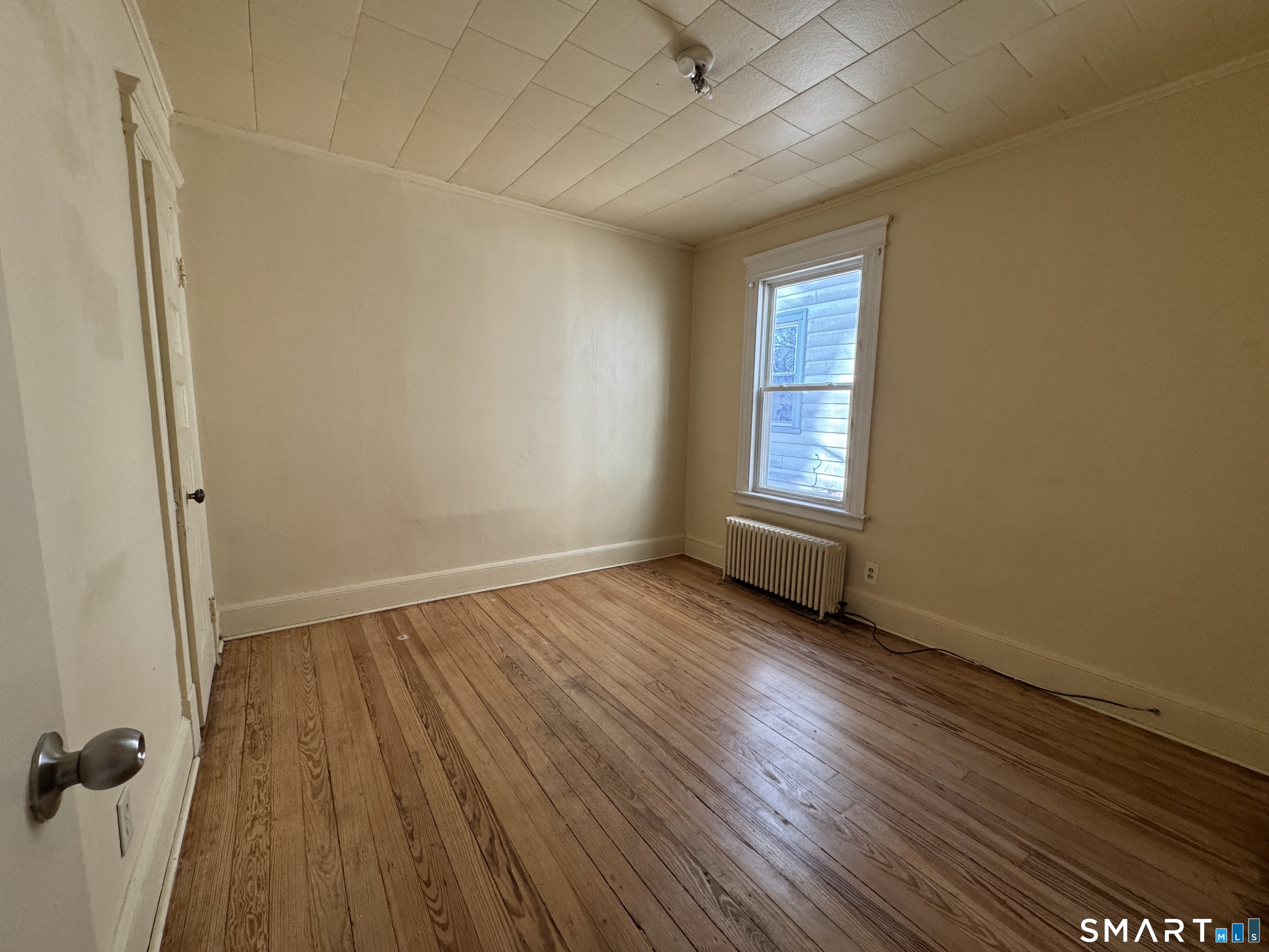 1720 East Main Street, Unit 1 Waterbury, CT 06705 - Photo 9 of 9 an empty room with wooden floor and windows