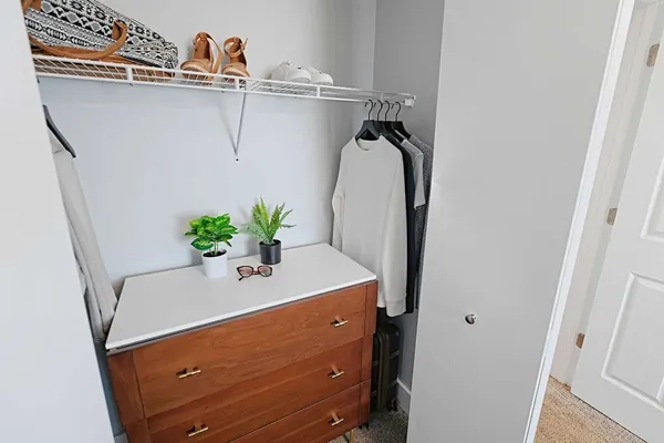 a bathroom with a bathtub a sink and mirror with toilet