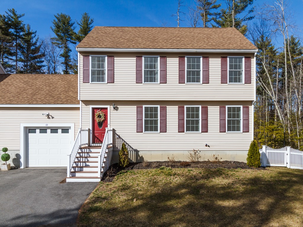 69 Ledge Road, Unit 69 Seabrook, NH 03874 - Photo 1 of 17 a front view of a house with a yard