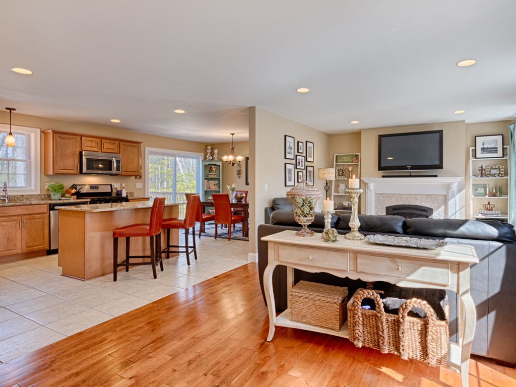 69 Ledge Road, Unit 69 Seabrook, NH 03874 - Photo 11 of 17 a living room with fireplace furniture and a flat screen tv
