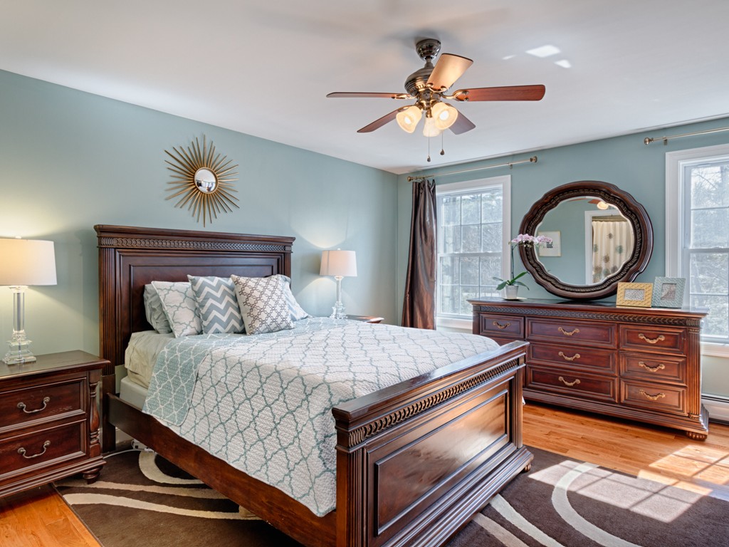 69 Ledge Road, Unit 69 Seabrook, NH 03874 - Photo 16 of 17 a bedroom with a bed and a chandelier