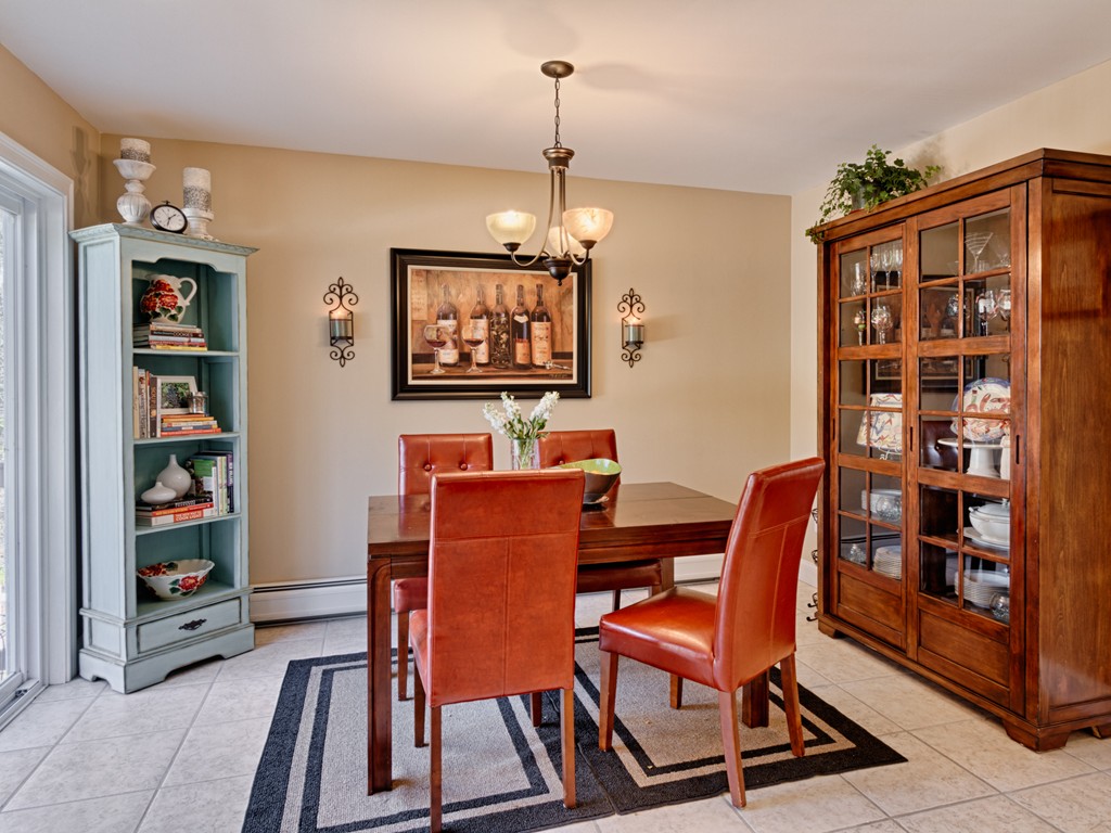 69 Ledge Road, Unit 69 Seabrook, NH 03874 - Photo 4 of 17 a dining room with furniture and wooden floor