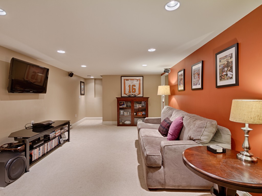69 Ledge Road, Unit 69 Seabrook, NH 03874 - Photo 7 of 17 a living room with furniture and a flat screen tv