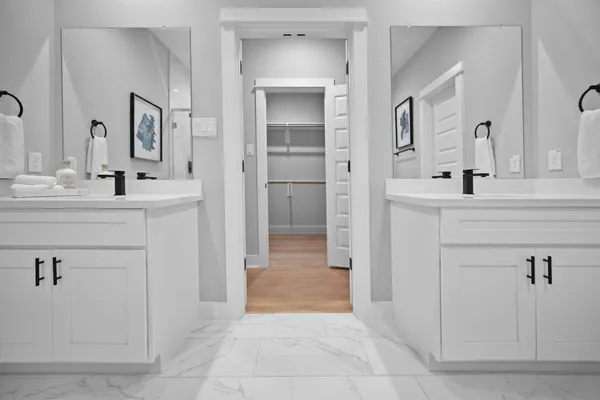 a bathroom with a double vanity sink mirror and