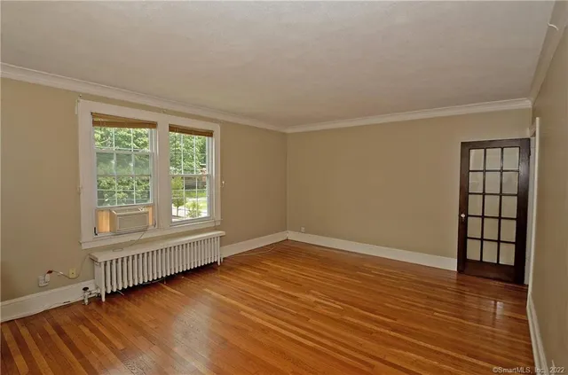 wooden floor in an empty room with a window
