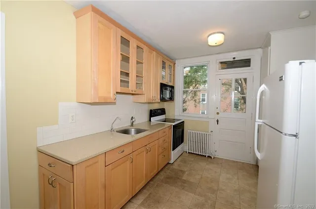 a kitchen with a refrigerator stove and sink