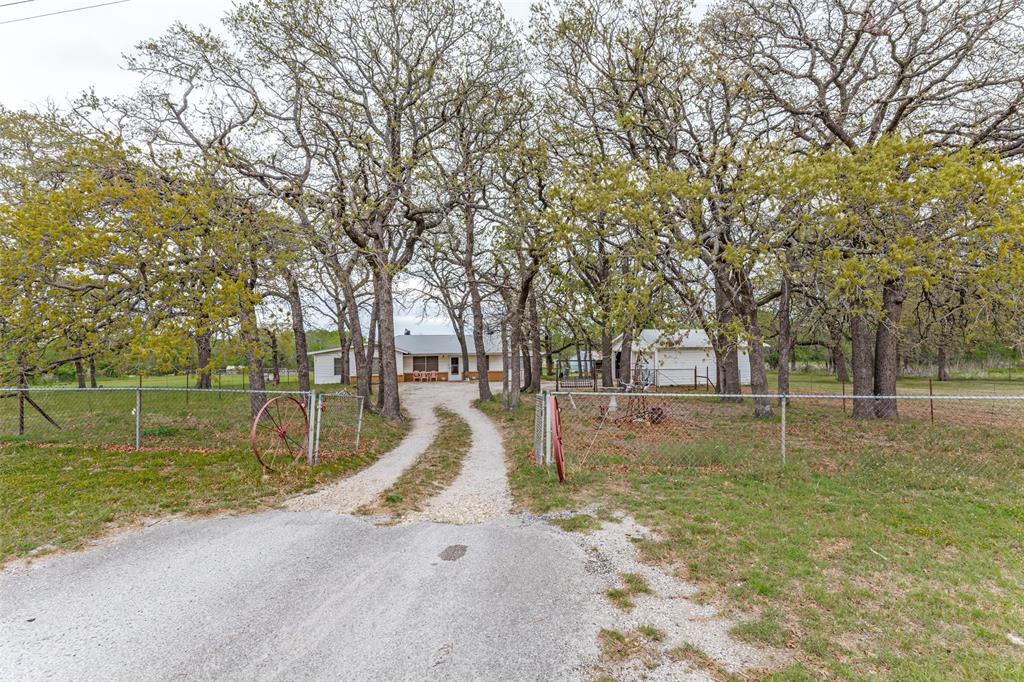 2553 East Highway 199 Springtown, TX 76082 - Photo 1 of 13 View of dirt / gravel road featuring a gated entry