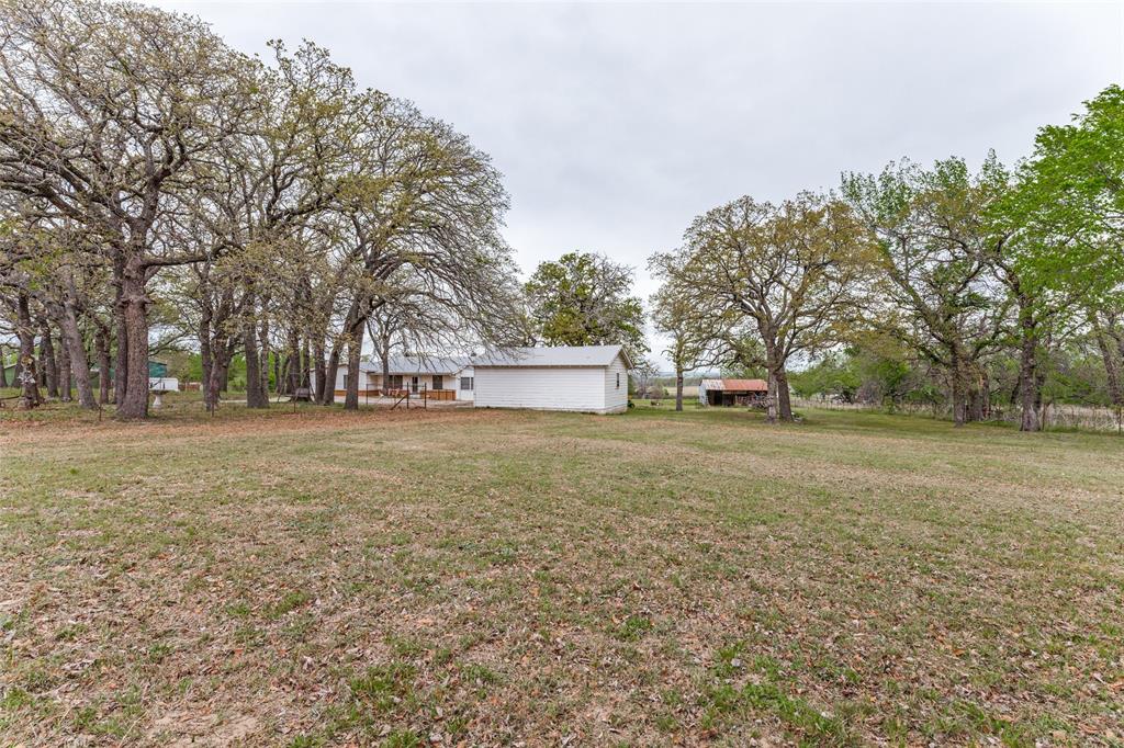 2553 East Highway 199 Springtown, TX 76082 - Photo 11 of 13 View of grassy yard with an outbuilding