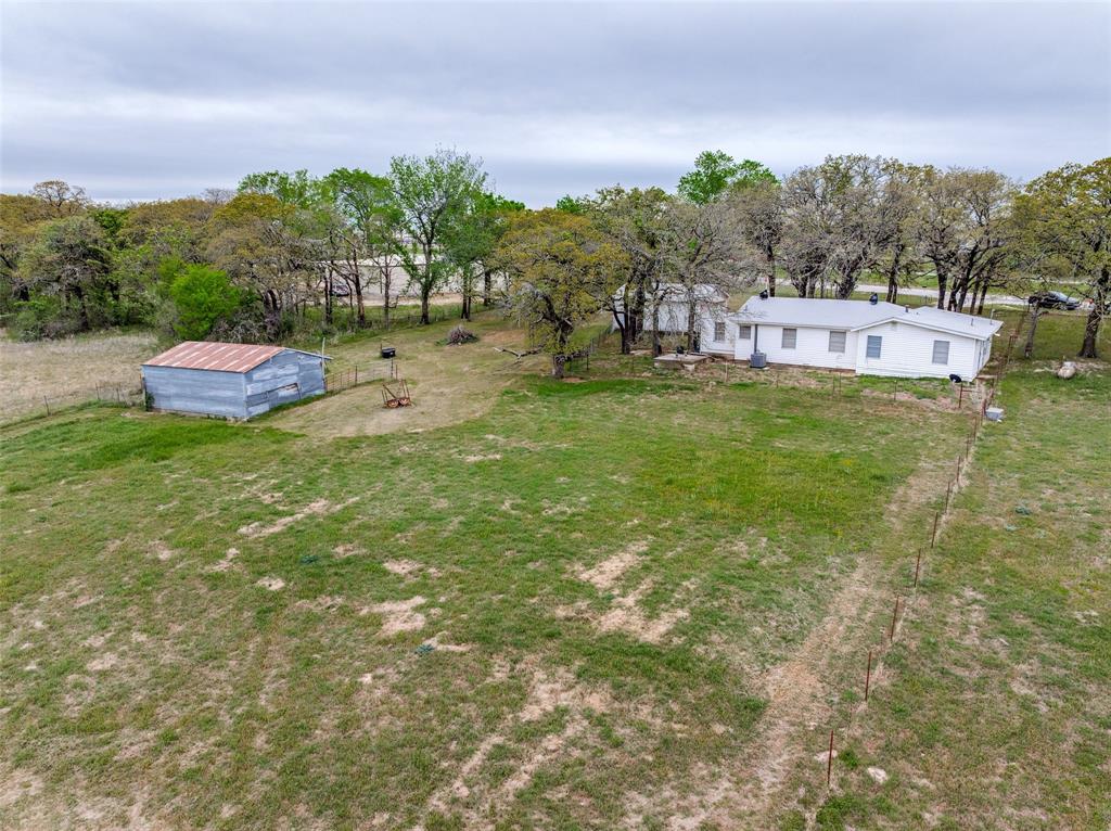 2553 East Highway 199 Springtown, TX 76082 - Photo 13 of 13 View of grassy yard featuring an outbuilding and view of scattered trees