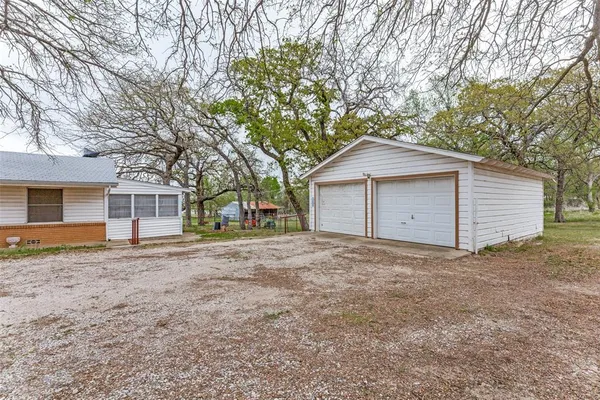 a view of a house with a yard and garage
