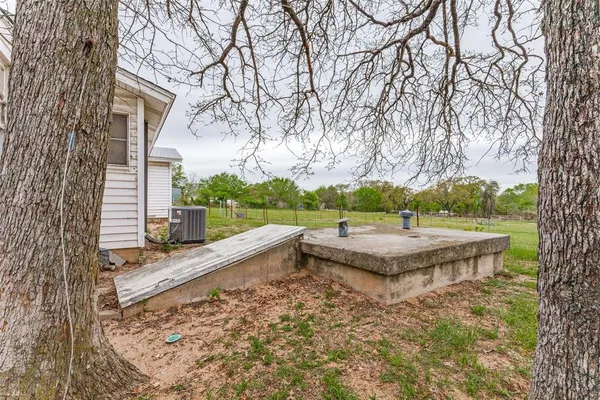 a view of a backyard and trees