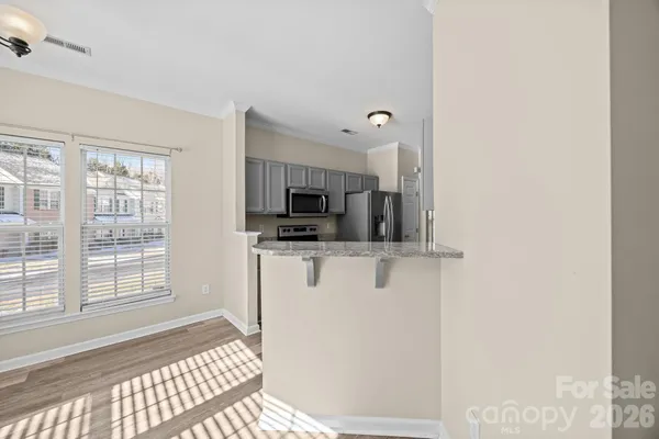 a view of a kitchen with an empty space and a window