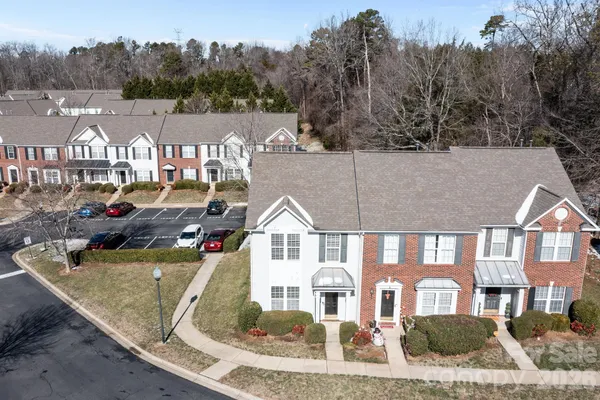 a view of multiple houses with a wrought fence