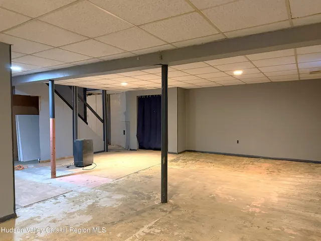 a front view of a house with a large tree