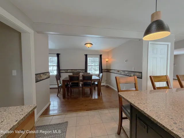 a view of a dining room with furniture and a window