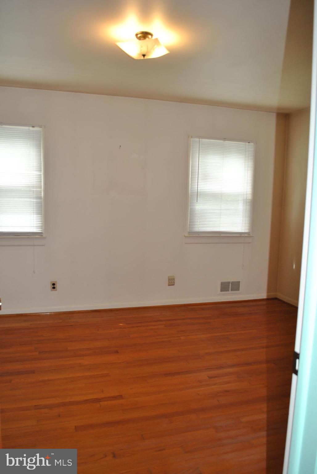 4902 Dumfries Road Catlett, VA 20119 - Photo 11 of 24 an empty room with wooden floor and windows