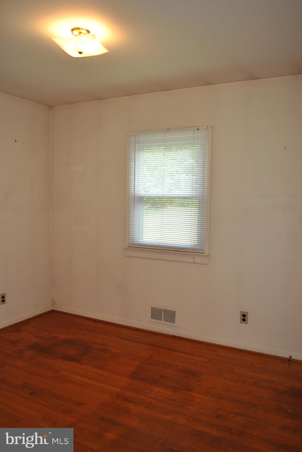 4902 Dumfries Road Catlett, VA 20119 - Photo 14 of 24 an empty room with wooden floor and a window