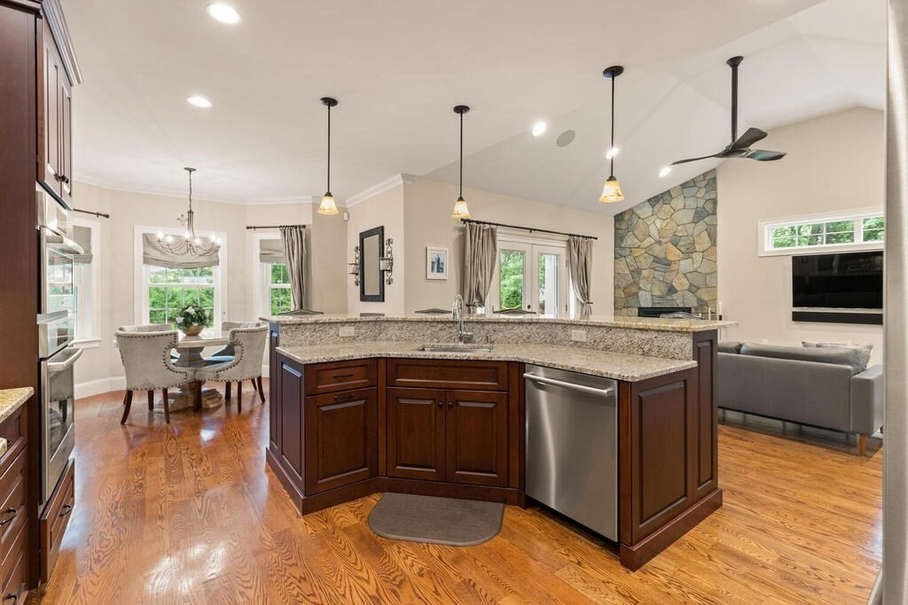 272 Boston Road Chelmsford, MA 01824 - Photo 16 of 42 a kitchen with stainless steel appliances granite countertop sink stove and wooden floor