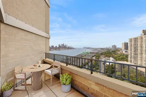 a view of a balcony with chairs and wooden floor