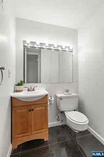 a bathroom with a sink a toilet and mirror