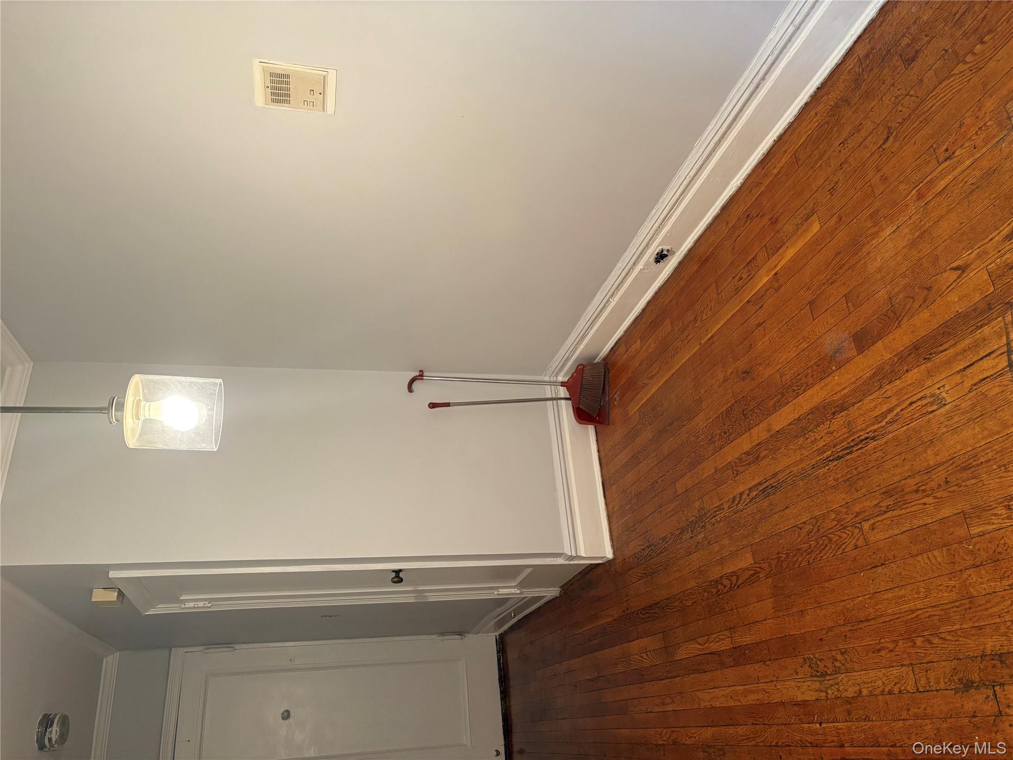 5005 43rd Avenue, Unit 5H Queens, NY 11377 - Photo 13 of 23 Spare room featuring dark wood-style floors and ornamental molding