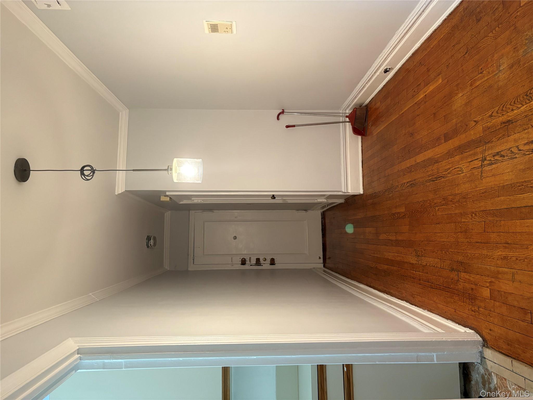 5005 43rd Avenue, Unit 5H Queens, NY 11377 - Photo 14 of 23 Corridor with dark wood-type flooring and ornamental molding