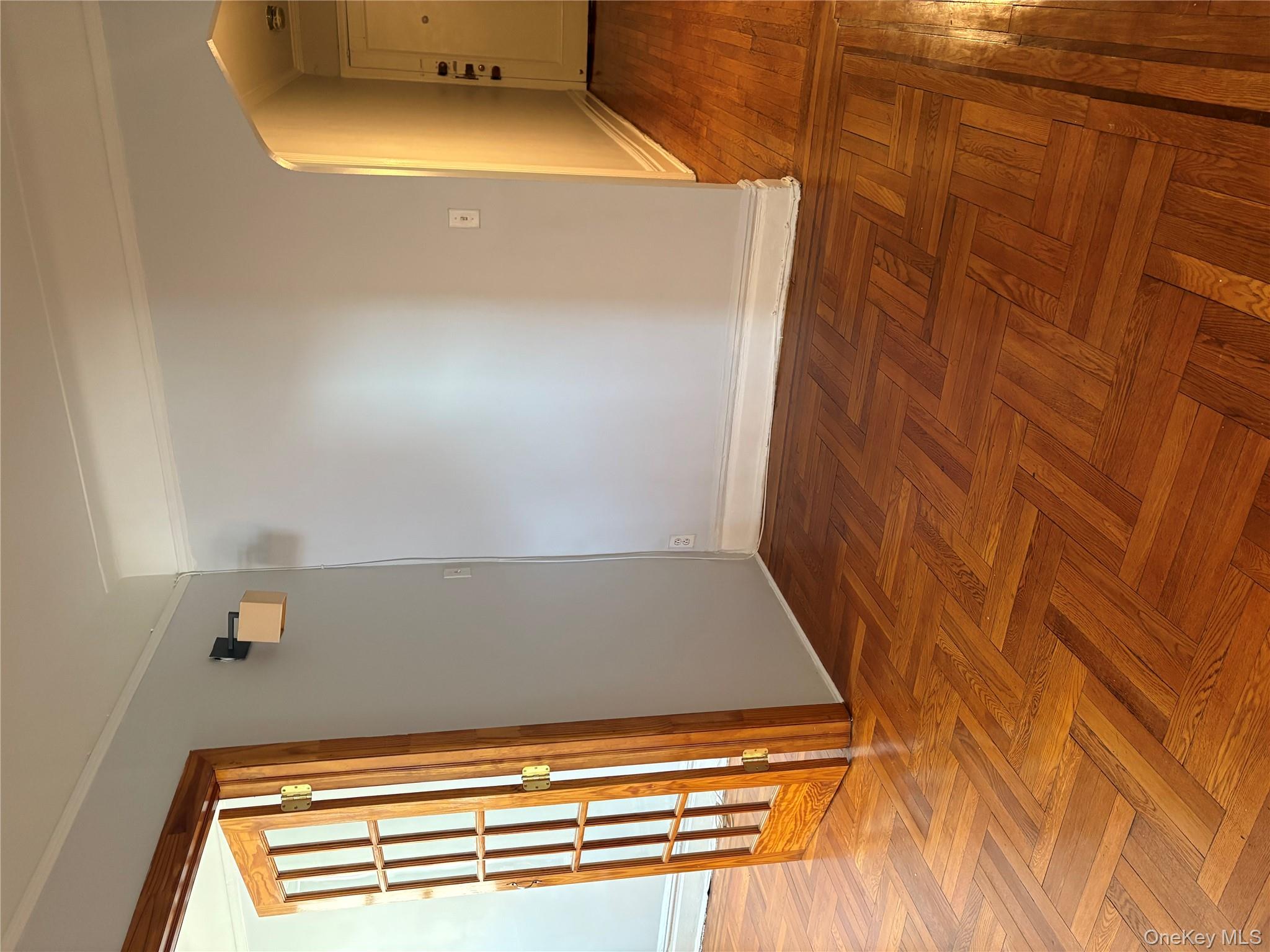 5005 43rd Avenue, Unit 5H Queens, NY 11377 - Photo 15 of 23 Unfurnished room with arched walkways and crown molding