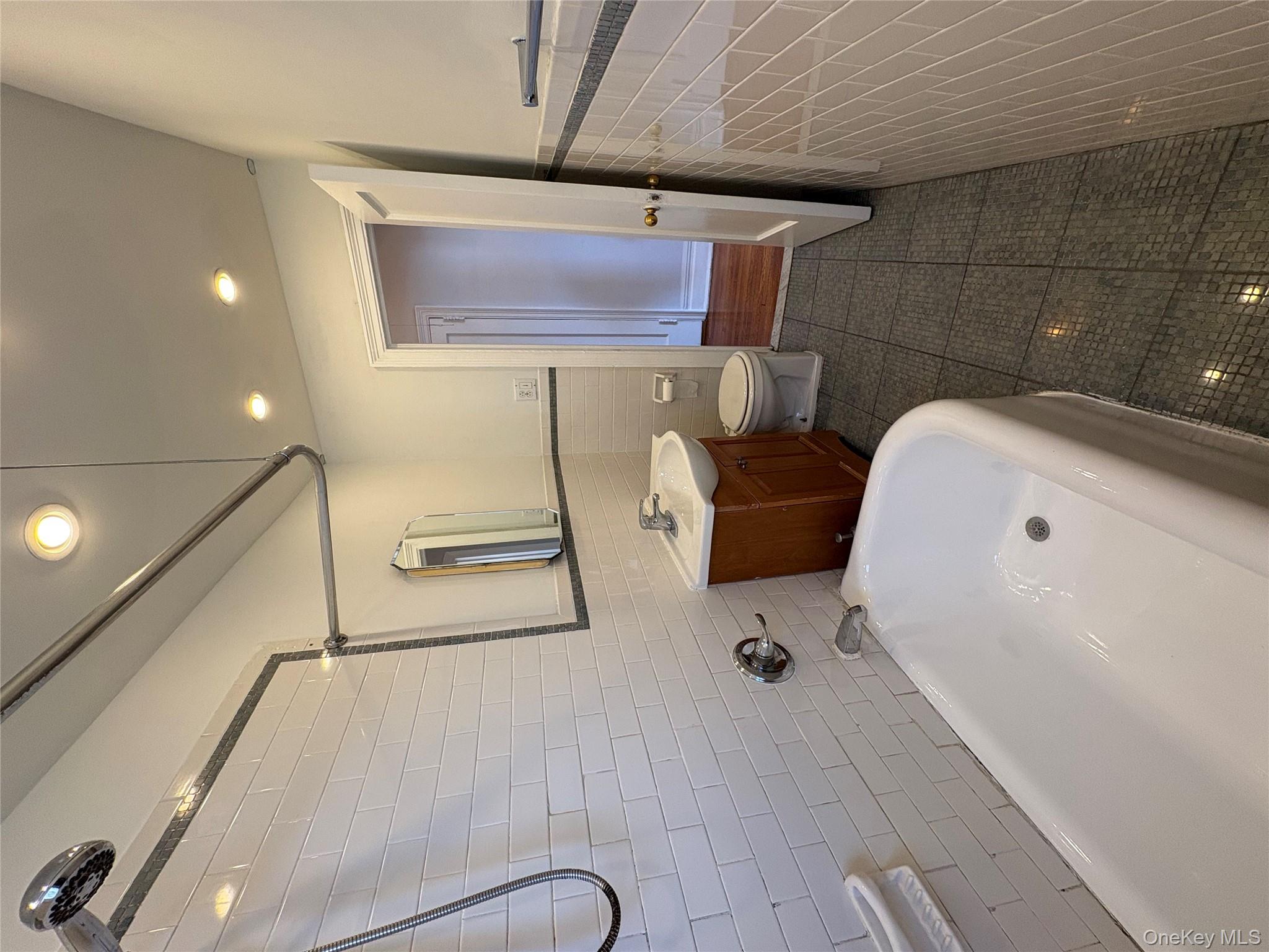 5005 43rd Avenue, Unit 5H Queens, NY 11377 - Photo 18 of 23 Bathroom featuring vanity, dark tile patterned floors, recessed lighting, tile walls, and tub / shower combination