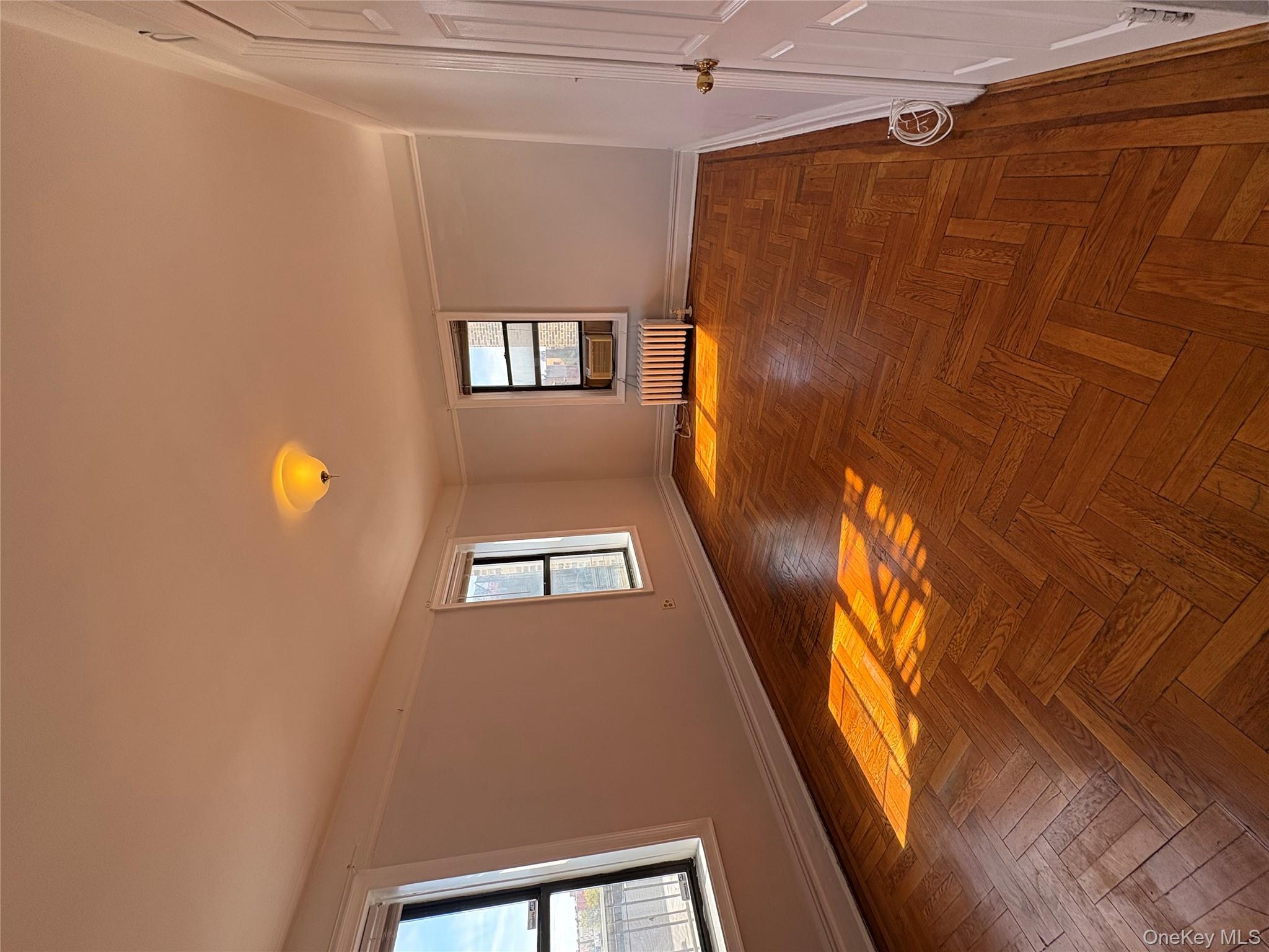 5005 43rd Avenue, Unit 5H Queens, NY 11377 - Photo 20 of 23 Spare room featuring plenty of natural light and radiator heating unit