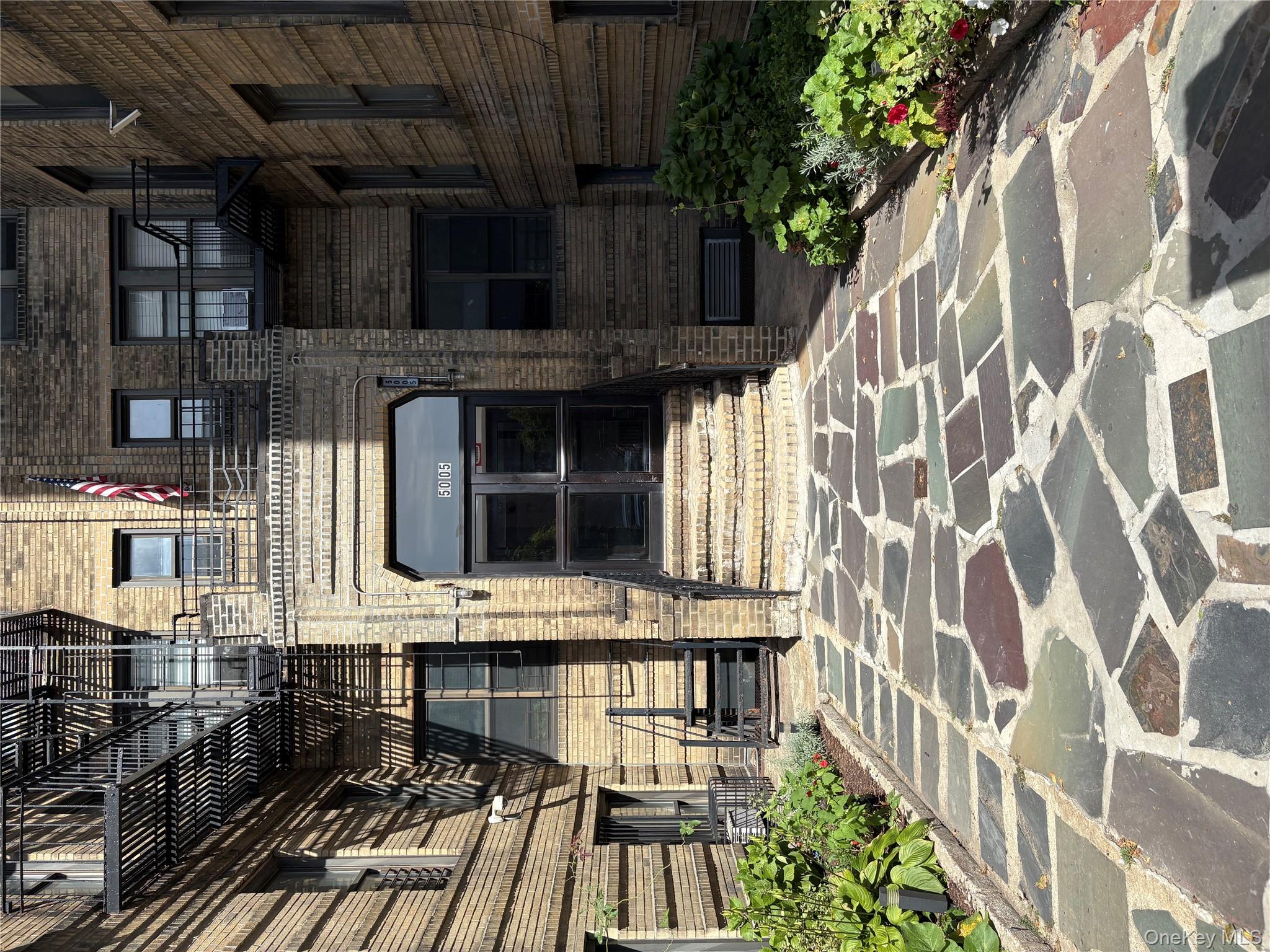 5005 43rd Avenue, Unit 5H Queens, NY 11377 - Photo 23 of 23 Property entrance featuring brick siding and a wall unit AC