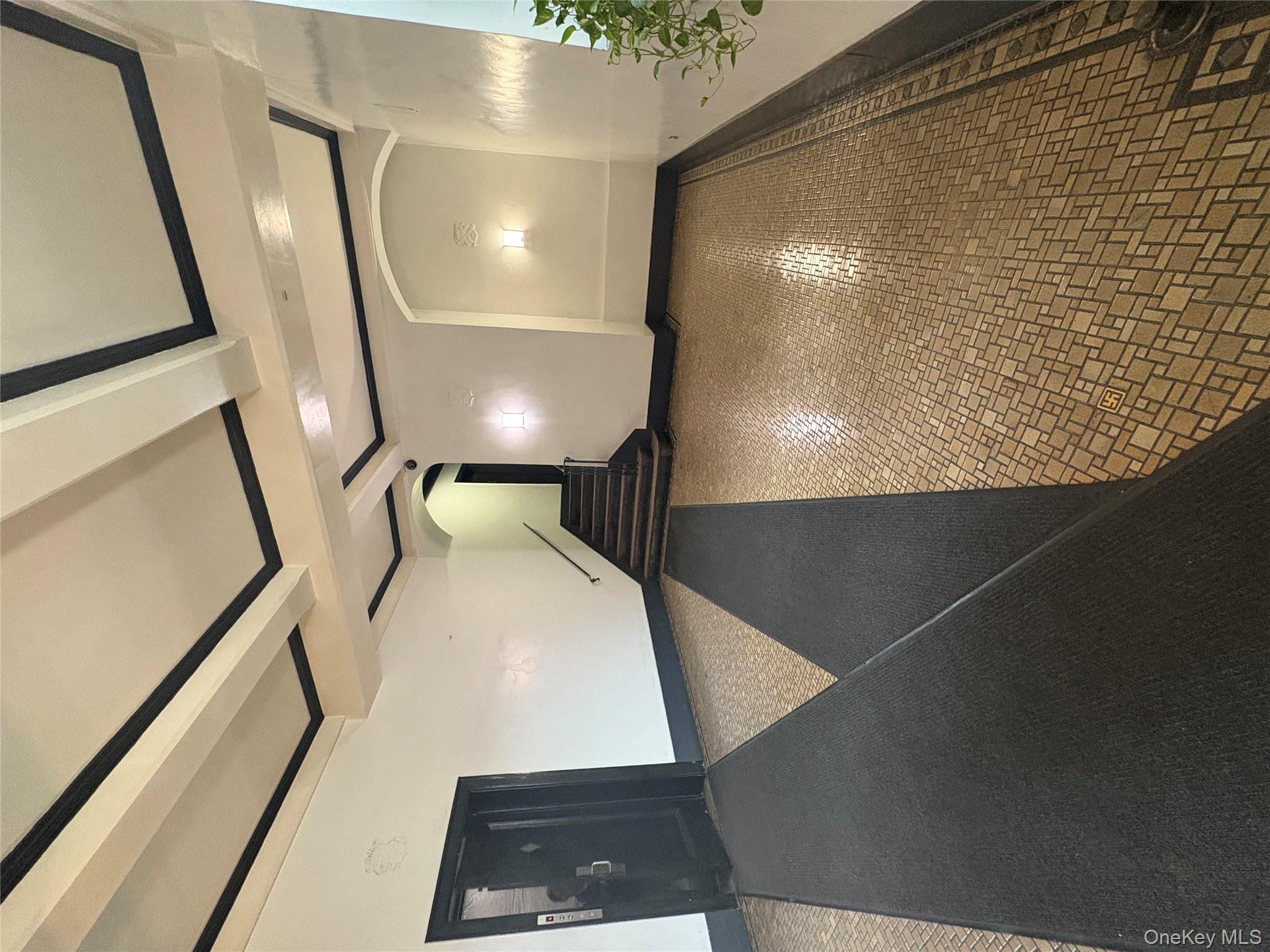 5005 43rd Avenue, Unit 5H Queens, NY 11377 - Photo 9 of 23 Hallway with beam ceiling and arched walkways