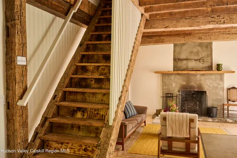 a view of a balcony with furniture and wooden floor