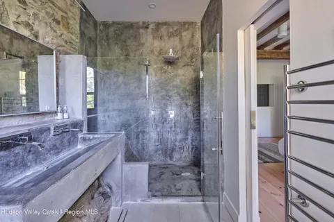 a bathroom with a granite countertop bathtub shower sink and mirror
