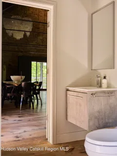 a bathroom with a toilet a sink and a mirror