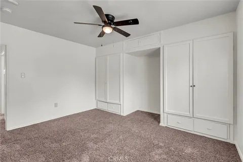 a view of a livingroom with a ceiling fan and window